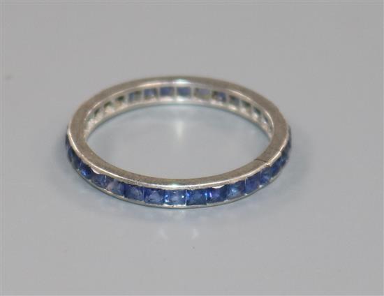 A white metal and sapphire set full eternity ring, size O.